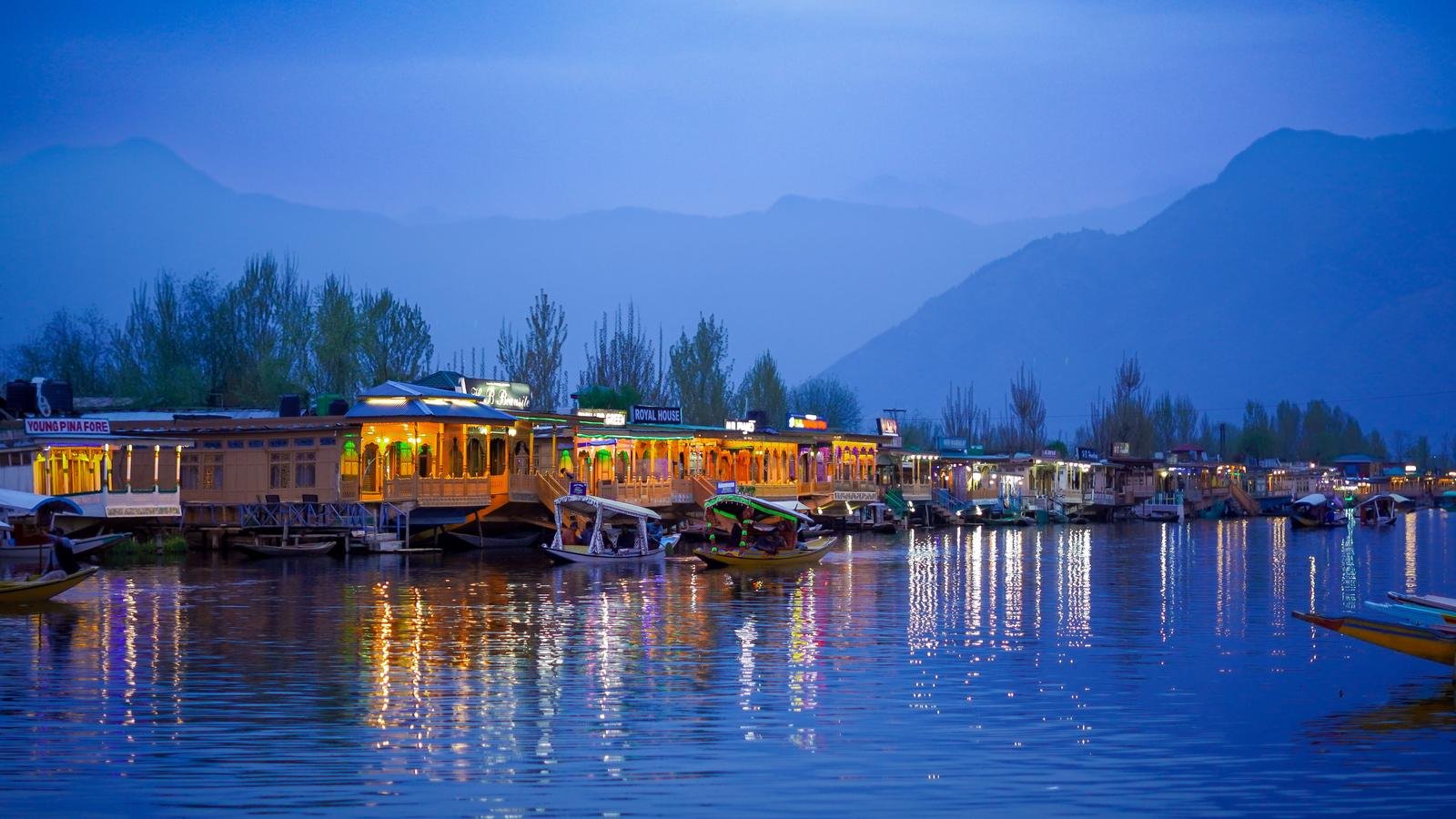 Lit houseboats on Dal Lake in Srinagar at twilight