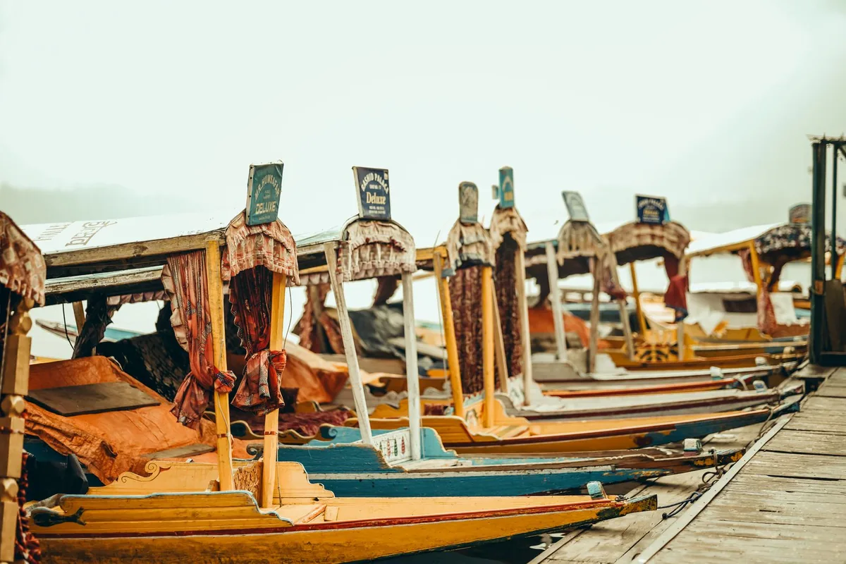 Colourful shikaras lined up at a Dal Lake ghat in Srinagar, an affordable highlight of a cheap Kashmir tour package
